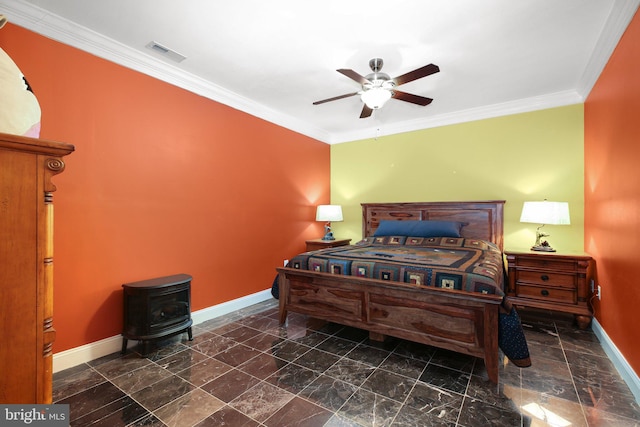 bedroom featuring a wood stove, ornamental molding, and ceiling fan