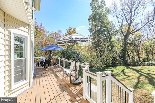 wooden terrace featuring a lawn