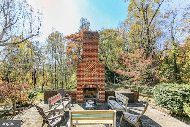 view of patio featuring an outdoor brick fireplace