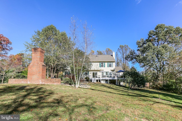 back of property featuring a yard