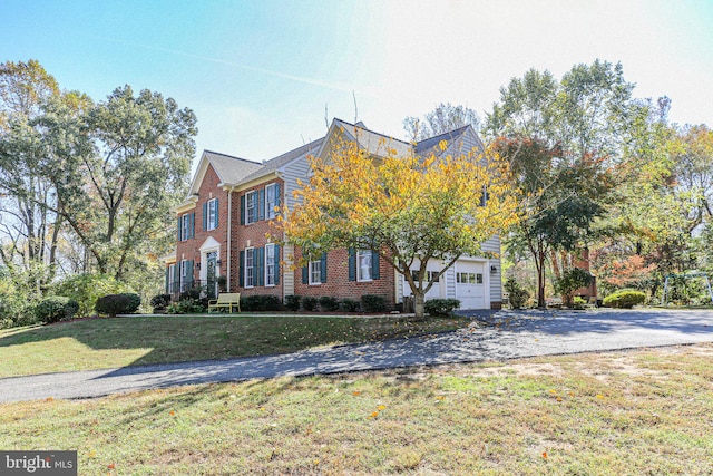 view of front of house with a front yard and a garage