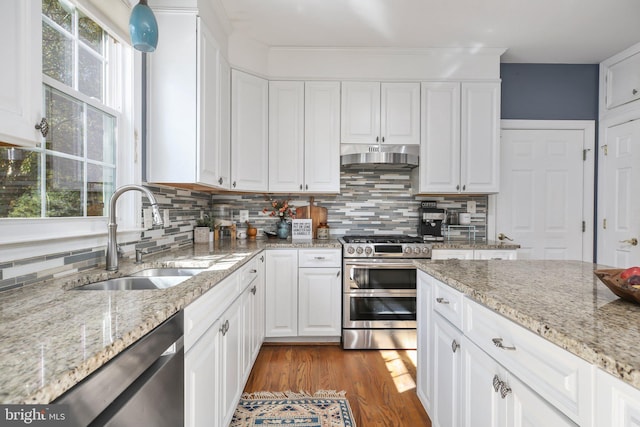 kitchen featuring sink, white cabinets, stainless steel appliances, and tasteful backsplash