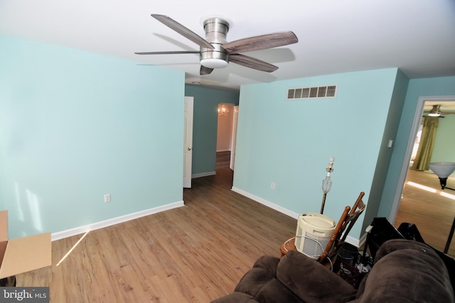 living room with hardwood / wood-style flooring and ceiling fan