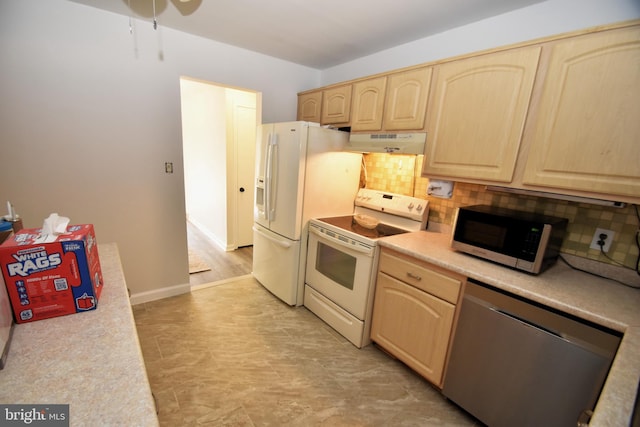 kitchen featuring stainless steel appliances, light brown cabinetry, and backsplash