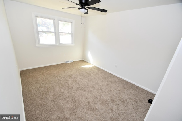 carpeted empty room with ceiling fan