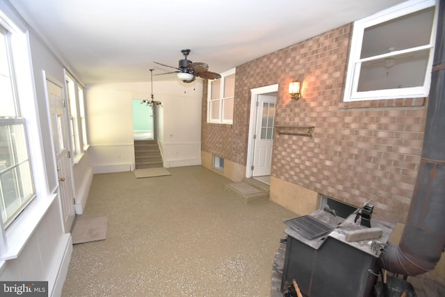 unfurnished living room with vaulted ceiling and ceiling fan