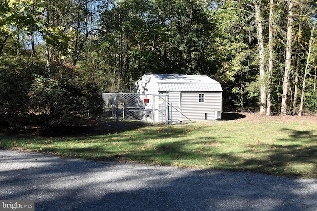 view of outbuilding featuring a lawn