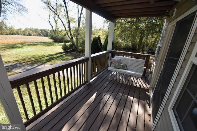 wooden terrace with a lawn