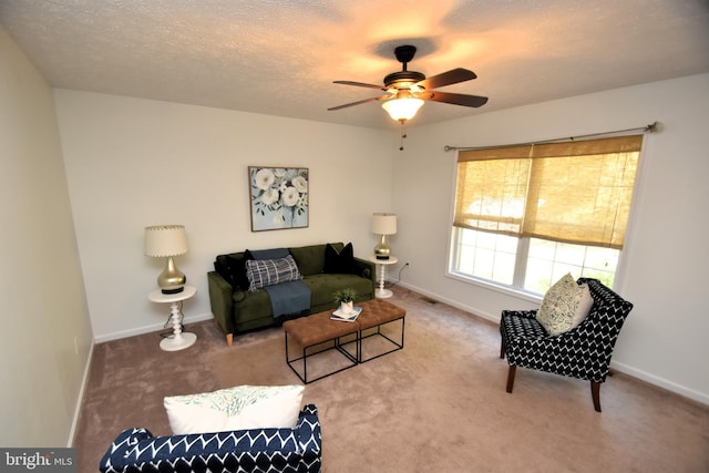 living room with carpet, a textured ceiling, and ceiling fan