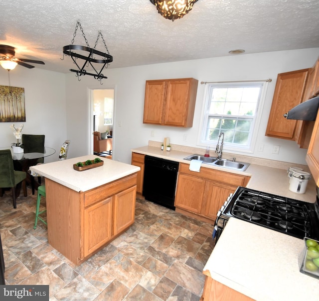 kitchen with a textured ceiling, white gas stove, dishwasher, sink, and a center island