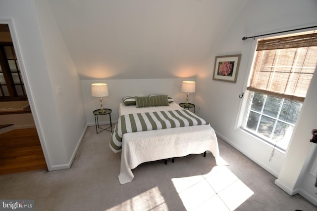 carpeted bedroom featuring vaulted ceiling