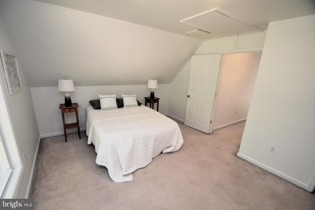 carpeted bedroom with vaulted ceiling