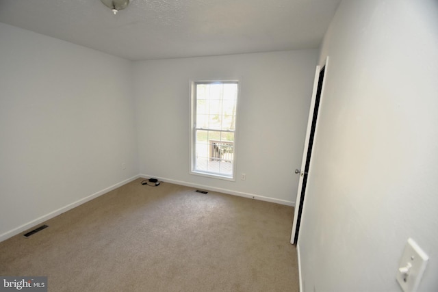 unfurnished room with light colored carpet