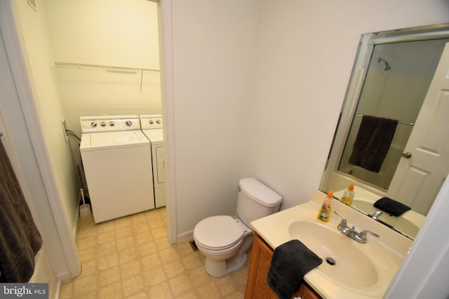 bathroom with vanity, independent washer and dryer, and toilet