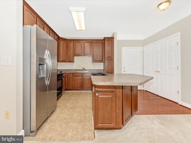 kitchen with light hardwood / wood-style floors, sink, ornamental molding, a kitchen island, and stainless steel fridge