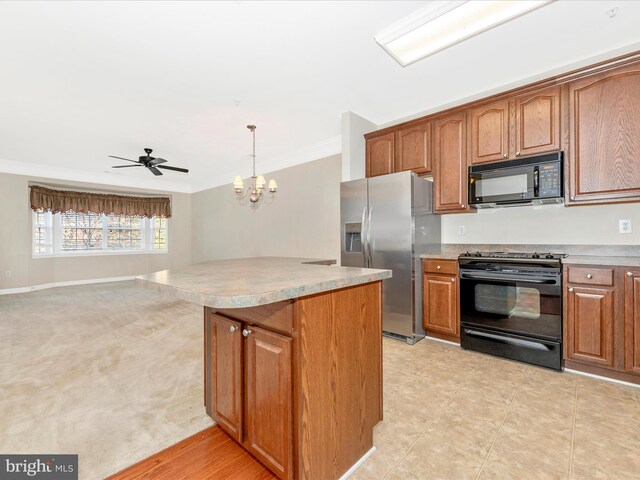 kitchen featuring black appliances, decorative light fixtures, ornamental molding, and a center island