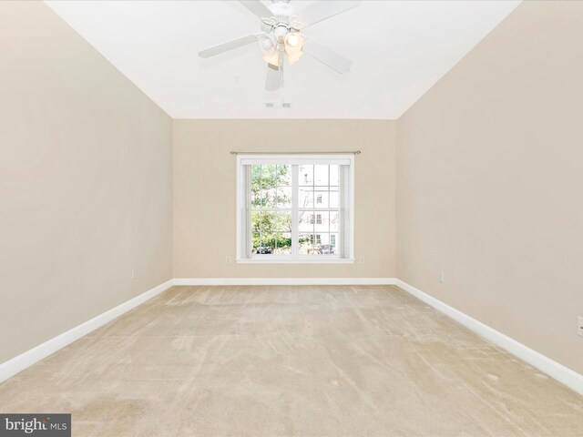 spare room with ceiling fan and light carpet