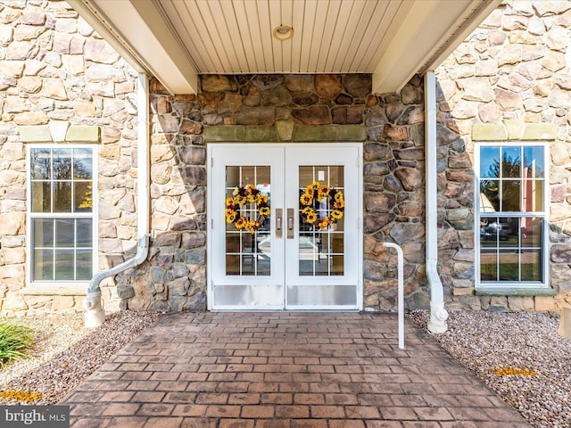 view of exterior entry featuring a patio and french doors