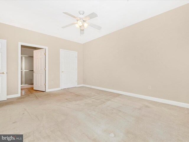 unfurnished bedroom with a closet, light carpet, and ceiling fan