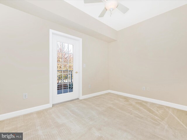 carpeted spare room featuring ceiling fan