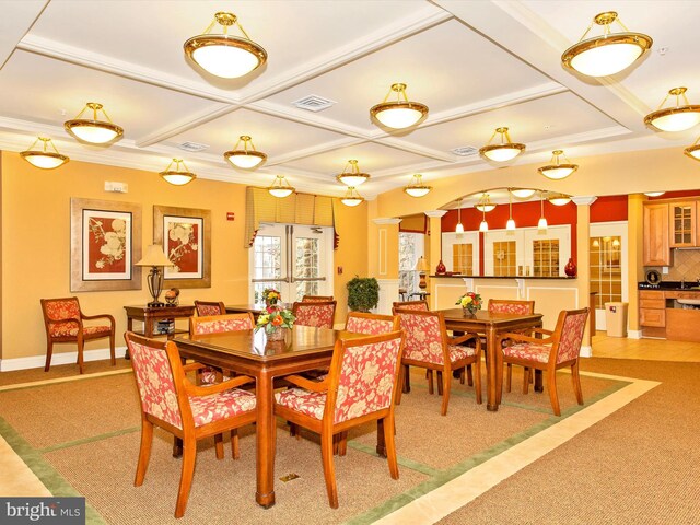 carpeted dining area featuring coffered ceiling and ornamental molding