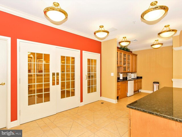 kitchen with french doors, dishwasher, light tile patterned flooring, crown molding, and dark stone countertops