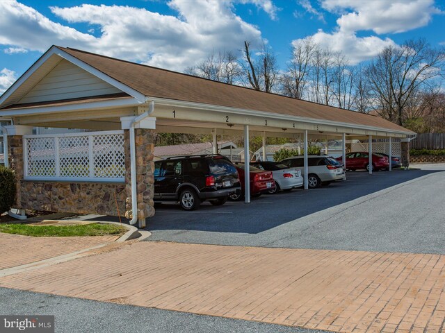 view of parking / parking lot featuring a carport