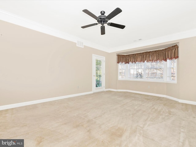 unfurnished room featuring light carpet, ceiling fan, and crown molding