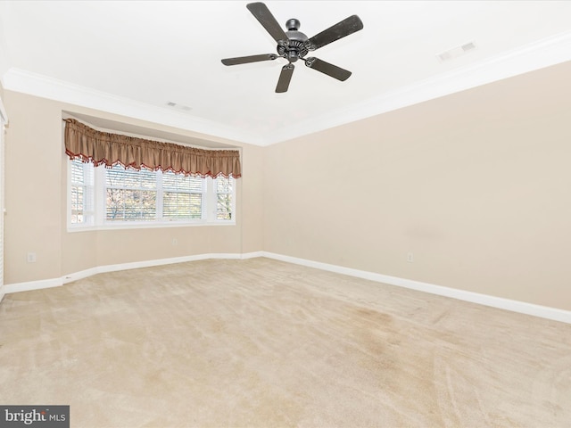 carpeted empty room with ceiling fan and ornamental molding