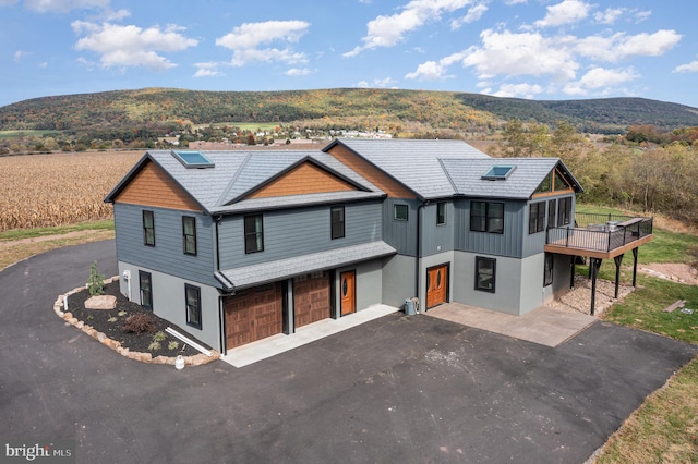 view of front of property featuring a garage and a mountain view