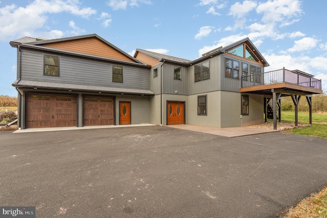 rear view of house with a garage