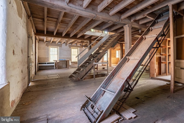 below grade area featuring wooden ceiling and stairs