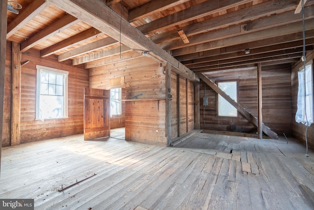 unfinished attic featuring a healthy amount of sunlight