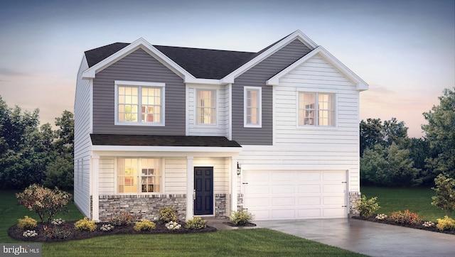 view of front of home with a yard and a garage