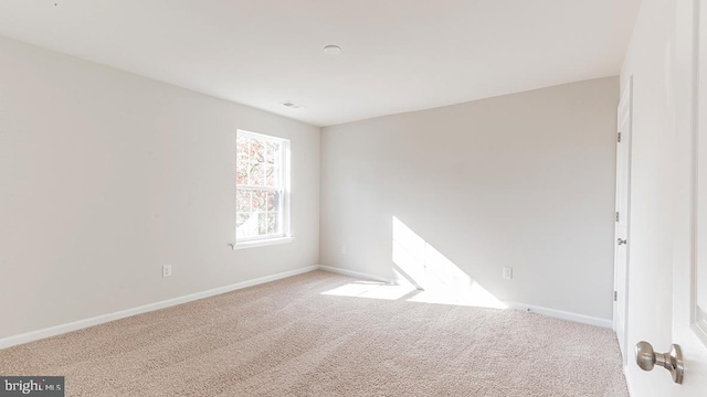 empty room featuring light colored carpet