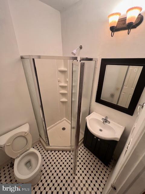 bathroom with vanity, toilet, and walk in shower