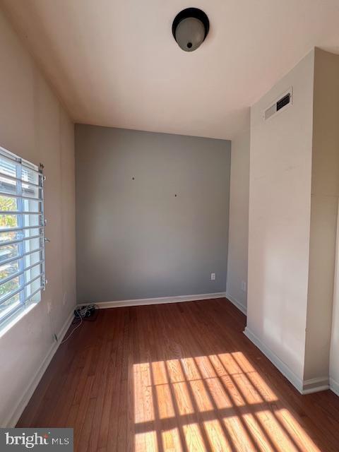 unfurnished room with wood-type flooring