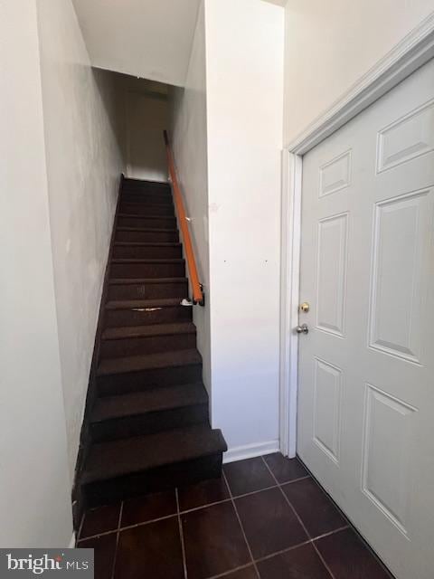 stairway featuring tile patterned floors