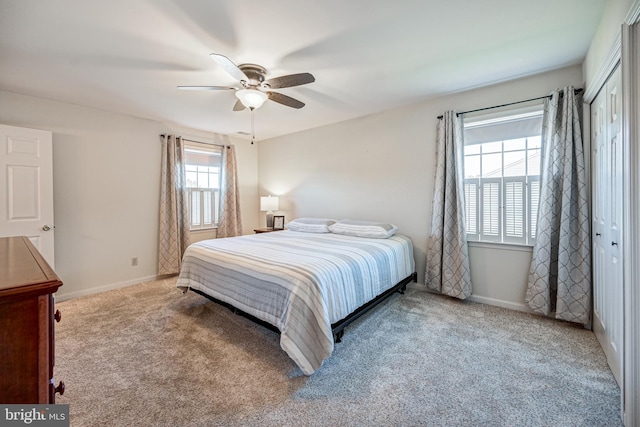 carpeted bedroom featuring a closet and ceiling fan