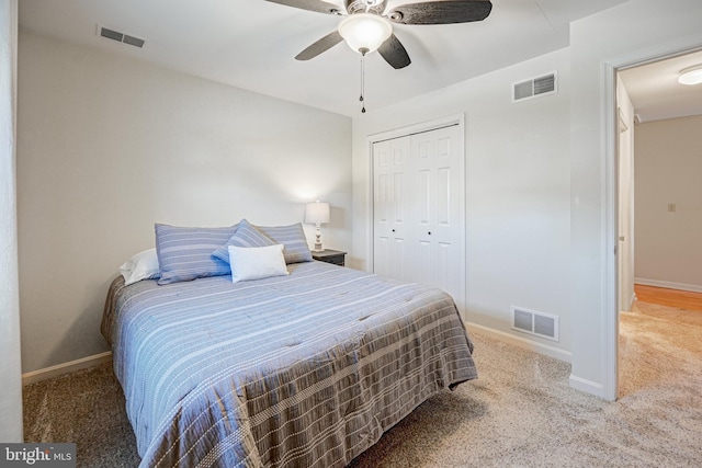 carpeted bedroom with a closet and ceiling fan