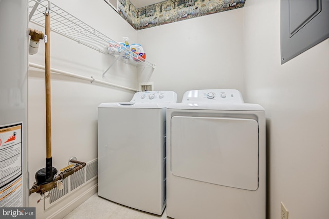 clothes washing area featuring washer and clothes dryer and light carpet