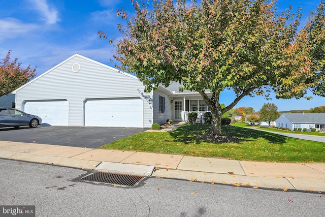 view of front of house featuring a front yard and a garage