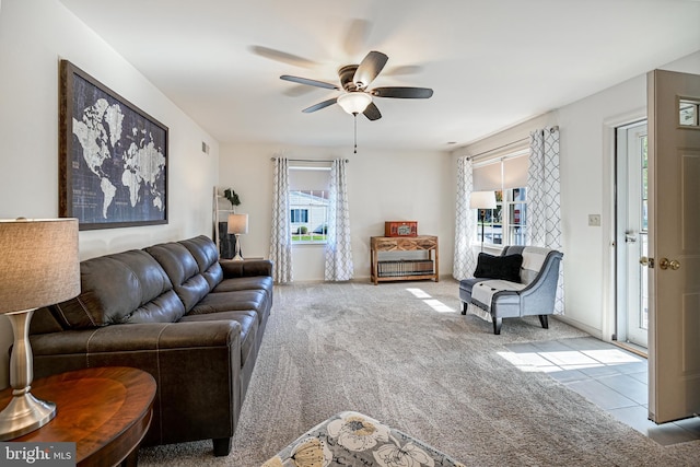 carpeted living room with ceiling fan