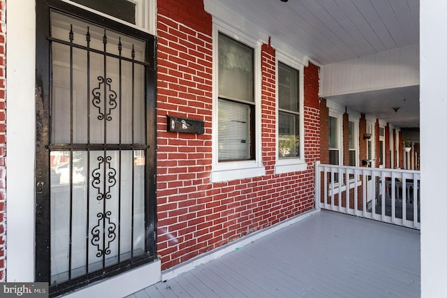 view of exterior entry with covered porch