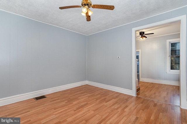 unfurnished room with light hardwood / wood-style floors, a textured ceiling, and ceiling fan