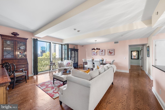 living room with a chandelier and dark hardwood / wood-style floors