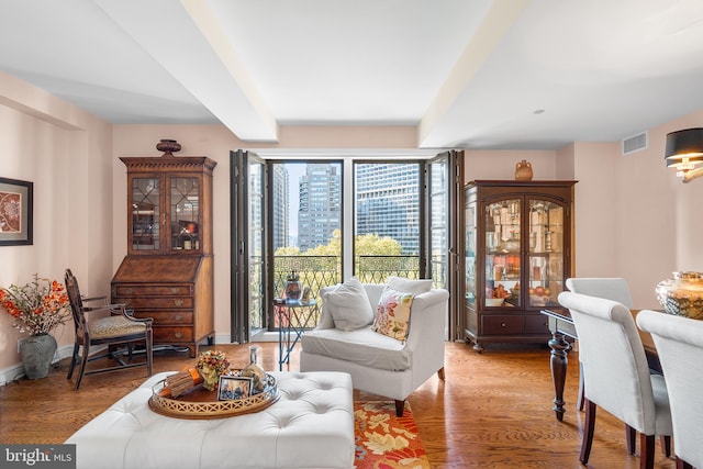 sitting room featuring beamed ceiling and light hardwood / wood-style flooring