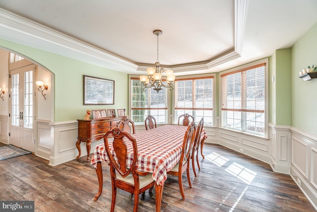 dining room with a raised ceiling, a notable chandelier, and a wealth of natural light