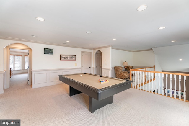 recreation room with a wainscoted wall, pool table, arched walkways, and ornamental molding