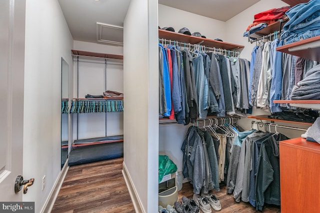 spacious closet with attic access and wood finished floors